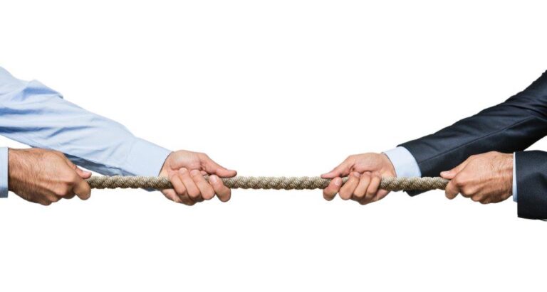 Business partners in a game of tug-of-war