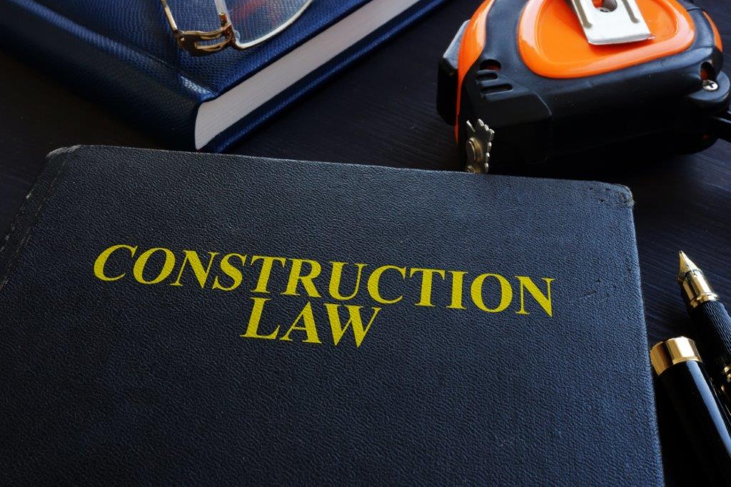 Book titled 'Construction Law' with construction tools nearby