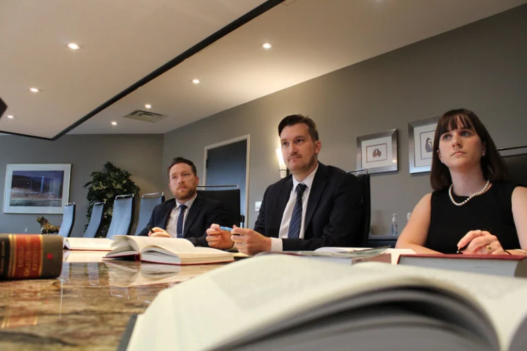 three lawyers in the Inch Hammond Boardroom