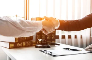 Lawyer and client shaking hands over legal meeting