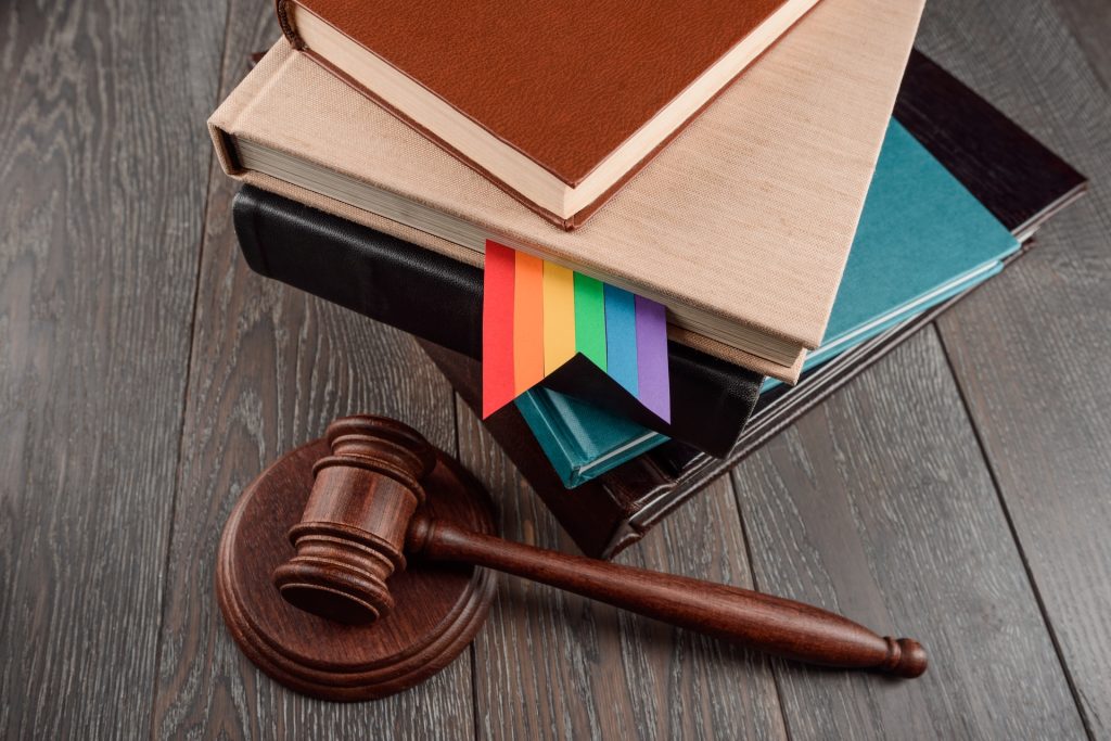 Stack of books with a rainbow flag and a gavel